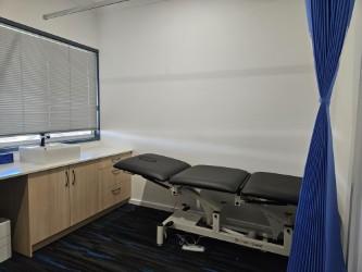 Consulting room with examination table at Employment Medicine