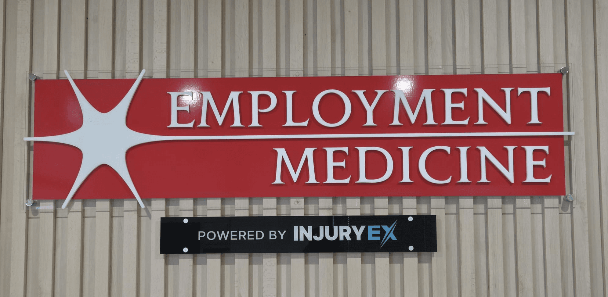 Employment Medicine and Powered by InjuryEX wall signage at the Parafield clinic